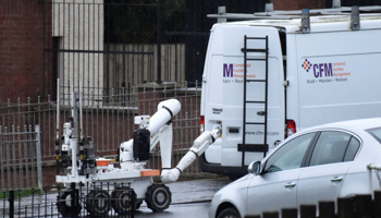 A bomb disposal robot opens a door of a suspected vehicle at the scene of a security alert in Londonderry, Northern Ireland, January 21 (Reuters/Clodagh Kilcoyne)