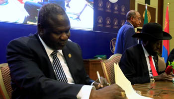 President Salva Kiir and opposition leader Riek Machar sign a power-sharing agreement in Khartoum, August 5, 2018 (Reuters/Mohamed Nureldin Abdallah)