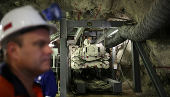 Workers at South Africa's Cullinan mine pilot a drill that uses vacuum air suction and laser-guided steering to achieve continuous boring (Reuters/Siphiwe Sibeko)