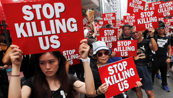 Protesters hold placards as they attend a demonstration demanding Hong Kong's leaders to step down and withdraw the extradition bill, in Hong Kong, China, June 16, 2019 (Reuters/Tyrone Siu)