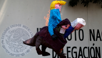 Activists burn a pinata depicting U.S. President Donald Trump and Mexican President Andres Manuel Lopez Obrador, April 6, 2019. (Reuters/Jose Cabezas)