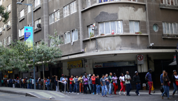 Immigrants queuing outside an immigration office in Santiago (Reuters/Ivan Alvarado)