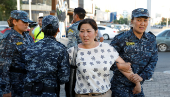 Police arrest a participant in an opposition protest in the Kazakh capital Nur-Sultan (Reuters/Mukhtar Kholdorbekov)