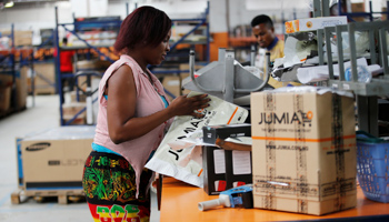 A woman works at the packaging unit at a warehouse for Jumia in Lagos, 2016 (Reuters/Akintunde Akinleye)