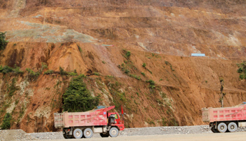 Trucks are seen as copper output begins at the Chinese-owned Mirador mining project in Tundayme, Ecuador (Reuters/Daniel Tapia)