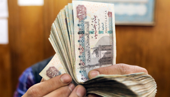 An employee counts Egyptian pounds at a foreign exchange office in central Cairo, Egypt, March 20 (Reuters/Mohamed Abd El Ghany)