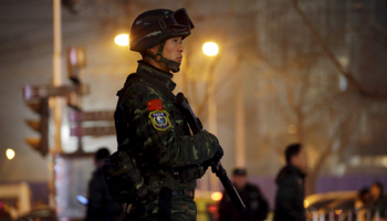 An armed policeman stands guard in Beijing, 2015 (Reuters/Jason Lee)