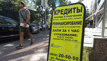 An advertising board for a financial agency offering loans in display in a street in Stavropol (Reuters/Eduard Korniyenko)