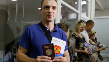 A resident of the rebel-held Donetsk region of eastern Ukraine with his new Russian passport (Reuters/Alexander Ermochenko)