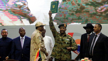 Lieutenant General Abdel Fattah Al-Burhan, the new chair of the sovereign council, celebrates the signing of the power-sharing deal (Reuters/Mohamed Nureldin Abdallah)