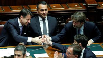 Italian Prime Minister Giuseppe Conte is congratulated by ministers after he presented his government's programme ahead of confidence vote at the Parliament in Rome, Italy (Reuters/Remo Casilli)