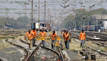 Men working at a railway track in Ahmedabad (Reuters/Amit Dave)