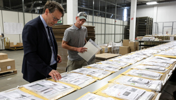 Canada's Chief Electoral Officer Stephane Perrault looks at materials at the Elections Canada distribution centre in advance of the upcoming federal election, Ottawa, August 29 (Reuters/Chris Wattie)