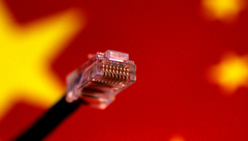 A computer network cable is seen above a Chinese flag (Reuters/Thomas White)
