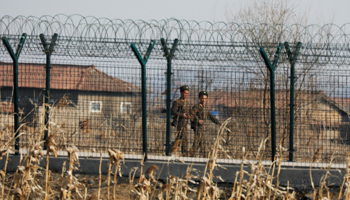 North Korean soldiers patrol behind a border fence near the North Korean town of Sinuiju, March 31, 2017 (Reuters/Damir Sagolj)