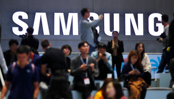 People sit in front of a Samsung logo at the IFA consumer tech fair in Berlin, Germany, September 6 (Reuters/Hannibal Hanschke)