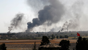 Smoke rises over the Syrian town of Tal Abyad amid Turkish bombardments, October 10 (Reuters/Murad Sezer)