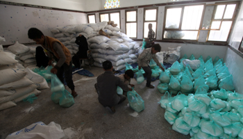 Workers prepare aid from the World Food Programme for distribution in Sana'a, August 21 (Reuters/Mohamed al-Sayaghi)