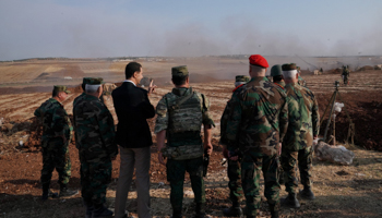 Syrian President Bashar al-Assad and army troops above war-torn northwestern Idlib province, Syria (Reuters/SANA Handout)