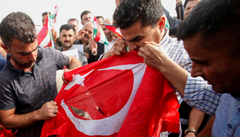 Iraqi Kurds tear the Turkish flag during a demonstration against Turkey's incursion in Syria, October 12 (Reuters/Azad Lashkari)