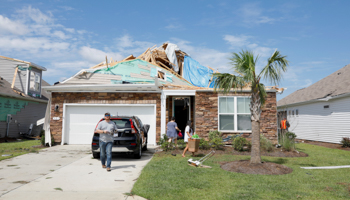 Residents salvage belongings from their damaged home after a tornado spawned by Hurricane Dorian ripped open its roof, in Carolina Shores, North Carolina, US, September 6 (Reuters/Jonathan Drake)