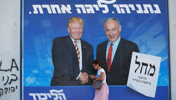 A woman walks past a Likud party election campaign banner depicting Israeli Prime Minister Benjamin Netanyahu and US President Donald Trump in Tel Aviv, September 16 (Reuters/Corinna Kern)