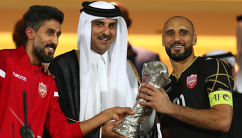Qatari Emir Tamim bin Hamad Al Thani congratulates Bahraini team members after their Gulf Cup victory in Doha, December 8 (Reuters/Ibraheem Al Omari)