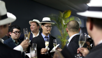 Cigar enthusiasts from China celebrate during the gala dinner for the closing of the XVIII Habanos Festival in Havana, March 4, 2016 (Reuters/Alexandre Meneghini)