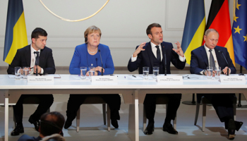 Ukrainian President Volodymyr Zelensky, German Chancellor Angela Merkel, French President Emmanuel Macron and Russian President Vladimir Putin attend a joint news conference on December 9 (Reuters/Charles Platiau)