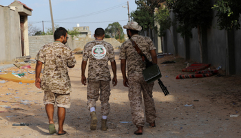 Members of the Libyan internationally recognized government forces carry weapons in Ain Zara, Tripoli, Libya October 14 (Reuters/Ismail Zitouny)