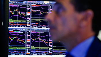 A trader looks at screens as he works on the floor at the New York Stock Exchange in New York, US, August 13 (Reuters/Eduardo Munoz)