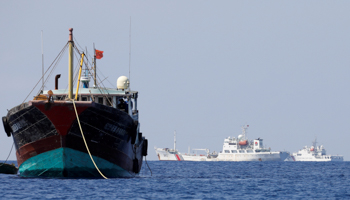 A Chinese fishing boat and Chinese coast guard vessels near Scarborough Shoal (Reuters/Erik De Castro)