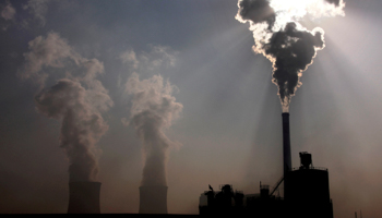 A coal-burning power plant behind a factory in China (Reuters/David Gray/File Photo)