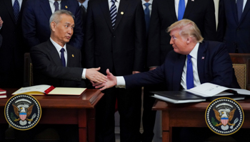 Chinese Vice Premier Liu He and US President Donald Trump shake hands after signing 'phase one' of the US-China trade agreement during a ceremony in the White House, Washington, January 15 (Reuters/Kevin Lamarque)