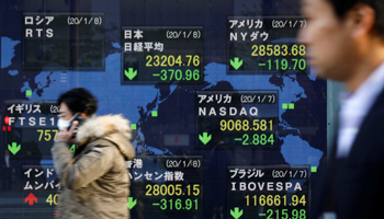 People walk past an electronic display showing world markets indices outside a brokerage in Tokyo, Japan, January 8, 2020 (Reuters/Issei Kato)