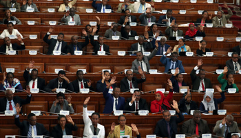 Ethiopian legislators raise their hands for the draft amendment paper of the anti-terrorism law before its approval inside the Parliament Building in Addis Ababa, Ethiopia January 2, 2020 (Reuters/Tiksa Negeri)