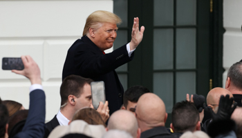 US President Donald Trump greets people after signing the United States-Mexico-Canada Agreement (USMCA) trade deal at the White House in Washington, US January 29, 2020 (Reuters/Jonathan Ernst)