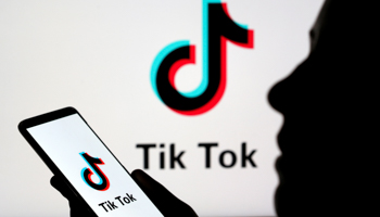A person holds a smartphone with Tik Tok logo displayed (Reuters/Dado Ruvic/Illustration)