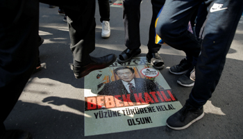 Ethnic Uighur demonstrators tread on image of Chinese President Xi Jinping outside the Chinese Consulate in Istanbul, October 1, 2019 (Reuters/Huseyin Aldemir)