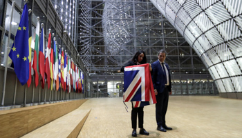 Officials remove the British flag at European Union Council in Brussels, Belgium January 31, 2020 (Reuters/Olivier Hoslet)