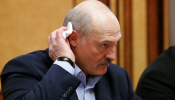 President Alexander Lukashenka listens to Russia's Vladimir Putin during their February 7 meeting. (Reuters/Alexander Zemlianichenko)