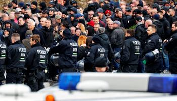 Police stand guard as supporters of Thomas Haller, founder of neo-Nazi group HooNaRa gather for his funeral in Chemnitz, March 2019 (Reuters/Fabrizio Bensch)