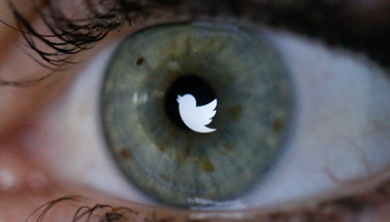 The Twitter logo reflected in the eye of a woman, 2013 (Reuters/Fabrizio Bensch)