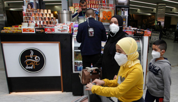 Passengers wearing face masks at Baghdad airport (Reuters/Khalid al)
