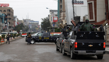 Iraqi security forces imposing a COVID-19 curfew in Baghdad (Reuters/Khalid al)