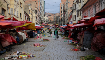 People walk at the closed Mercado Rodriguez street market after Bolivia's interim government announced a countrywide mandatory quarantine for 14 days to combat the spread of COVID-19 in La Paz, Bolivia, March 21 (Reuters/David Mercado)