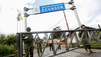 Ecuadoran soldiers stand guard at a border crossing with Colombia, after Ecuador's government announced the closure of its borders due to the spread of COVID-19, March 15 (Reuters/Daniel Tapia)