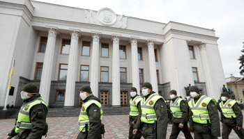 Ukrainian security forces patrol outside parliament during a crucial vote (Reuters/Valentyn Ogirenko)