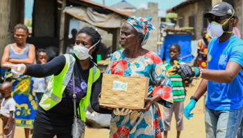Volunteers direct an elderly woman during a food distribution, Lagos, Nigeria, April 9 (Reuters/Temilade Ade)