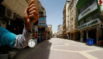 A watch showing the time as noon in a Najaf market emptied by COVID-19 (Reuters/Alaa al)